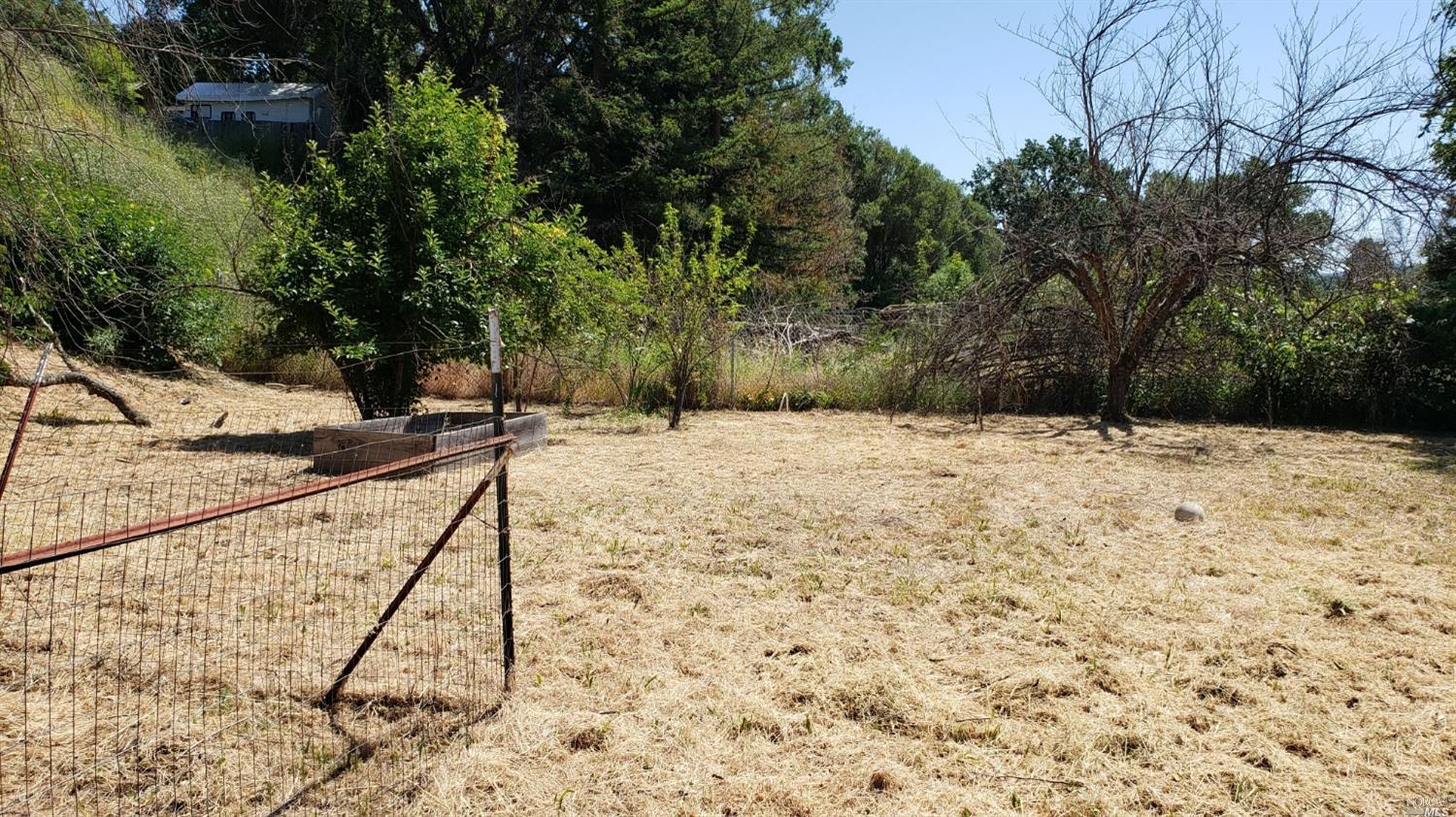 6060 Eastside Calpella Road Ukiah, CA 95482 - Photo 2 of 9 a view of wooden fence and a forest