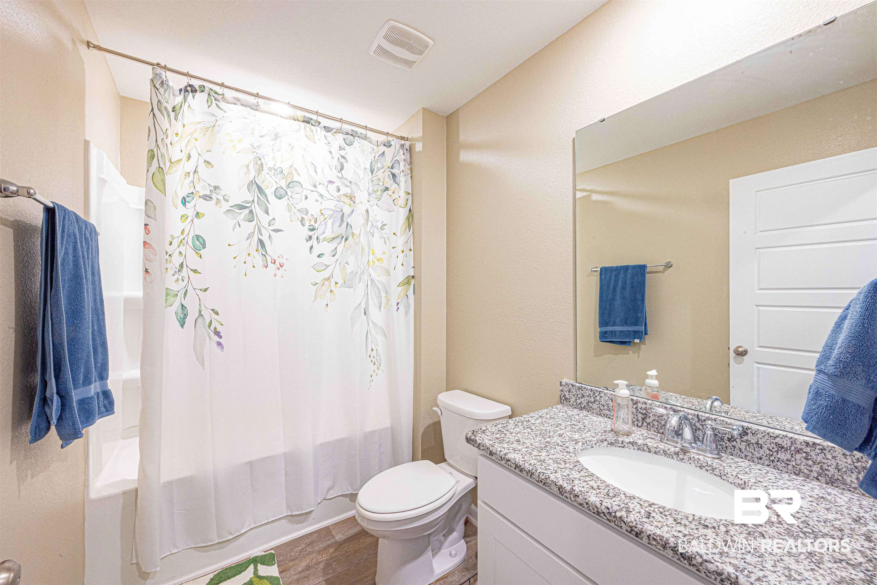 14843 Forsythia Loop Silverhill, AL 36576 - Photo 33 of 51 Full bath featuring shower / bath combo with shower curtain, vanity, and dark wood-type flooring