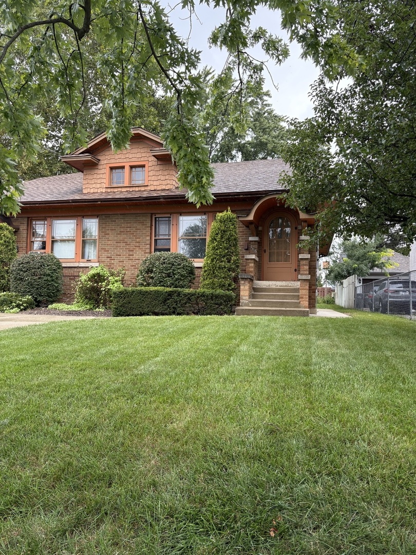 168 Harding Street Elgin, IL 60123 - Photo 1 of 8 a front view of a house with a yard