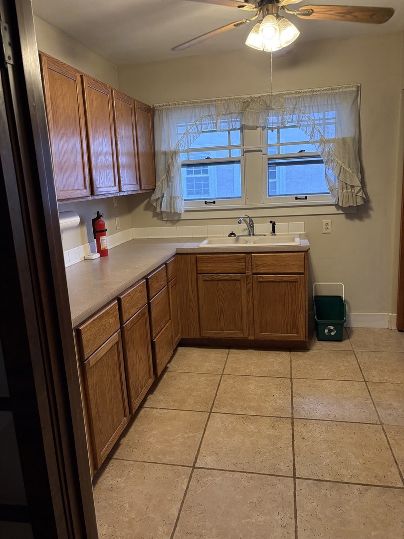 168 Harding Street Elgin, IL 60123 - Photo 5 of 8 a kitchen with stainless steel appliances granite countertop a sink and cabinets