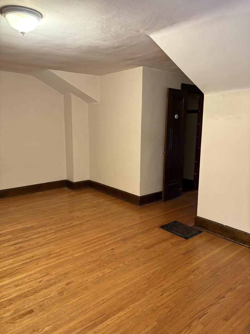 168 Harding Street Elgin, IL 60123 - Photo 8 of 8 a view of an empty room with wooden floor and closet