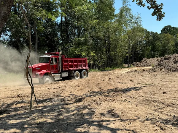 a wooden bench sitting in the middle of a yard