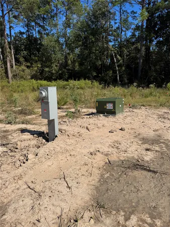 a view of a yard with wooden fence