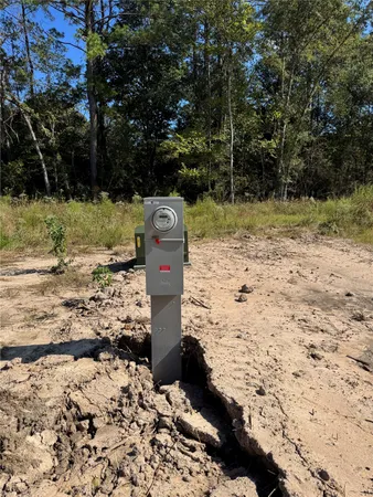 a view of a yard with wooden fence