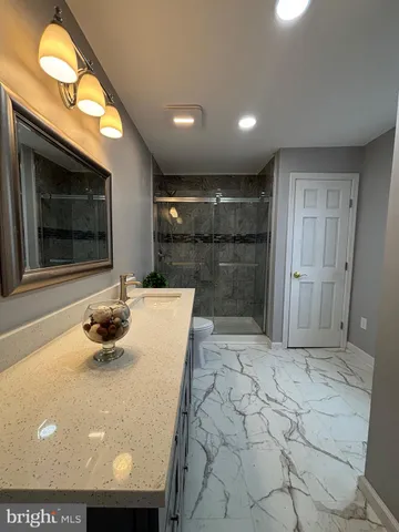 a view of bathroom with a sink and a mirror