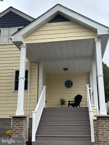 a view of a balcony with wooden floor and barbeque grill