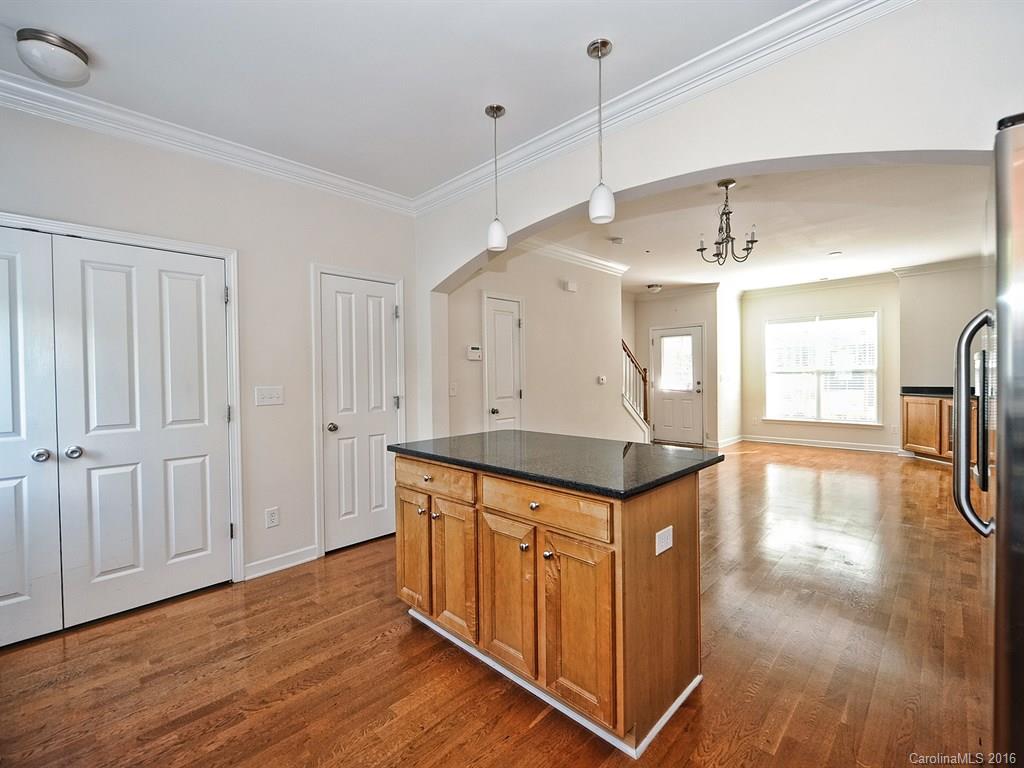 4142 Walker Road, Unit 4142 Charlotte, NC 28211 - Photo 11 of 22 a kitchen with granite countertop a stove and a wooden floors