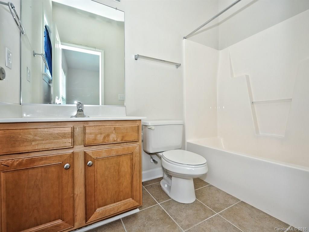 4142 Walker Road, Unit 4142 Charlotte, NC 28211 - Photo 19 of 22 a bathroom with a sink a toilet and shower