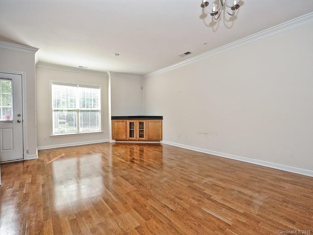 4142 Walker Road, Unit 4142 Charlotte, NC 28211 - Photo 5 of 22 a view of an empty room with wooden floor and a window