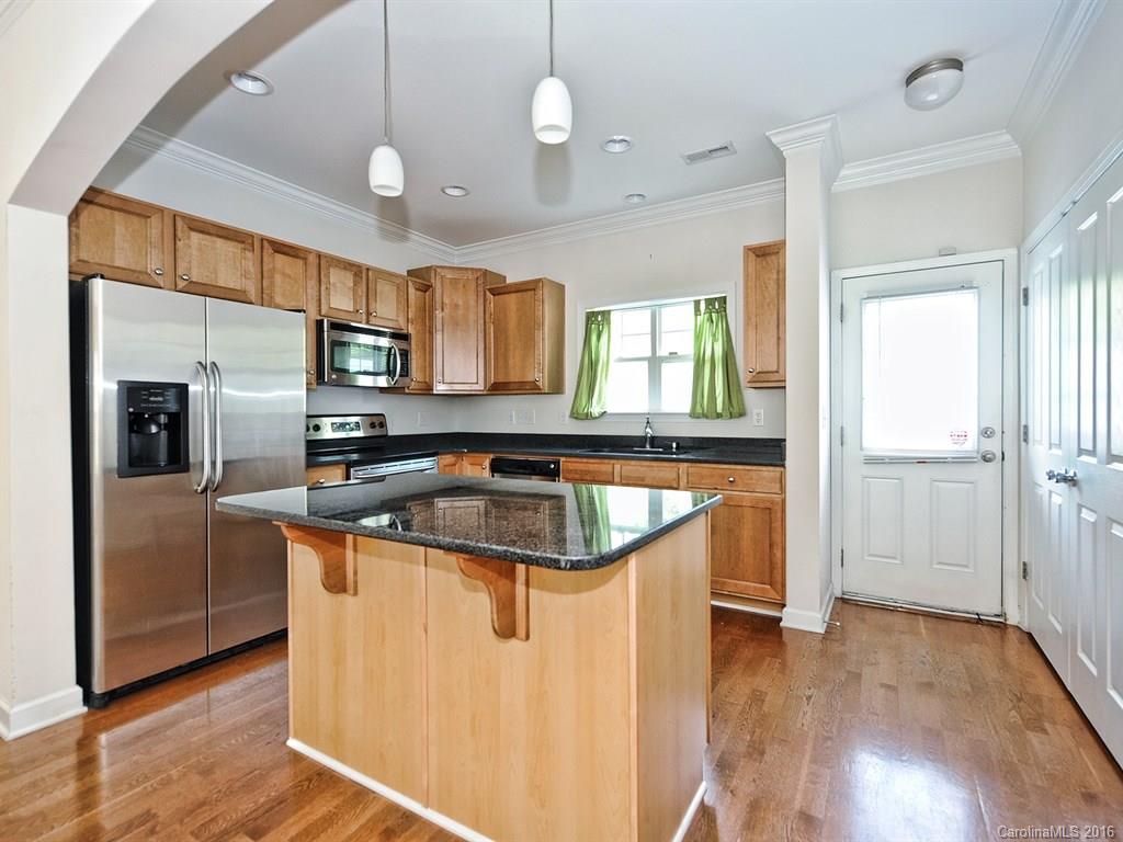 4142 Walker Road, Unit 4142 Charlotte, NC 28211 - Photo 7 of 22 a kitchen with stainless steel appliances granite countertop a sink a stove and a refrigerator