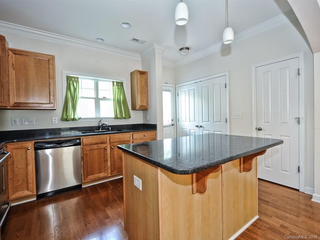 4142 Walker Road, Unit 4142 Charlotte, NC 28211 - Photo 9 of 22 a kitchen with stainless steel appliances granite countertop a sink a stove window and wooden floor