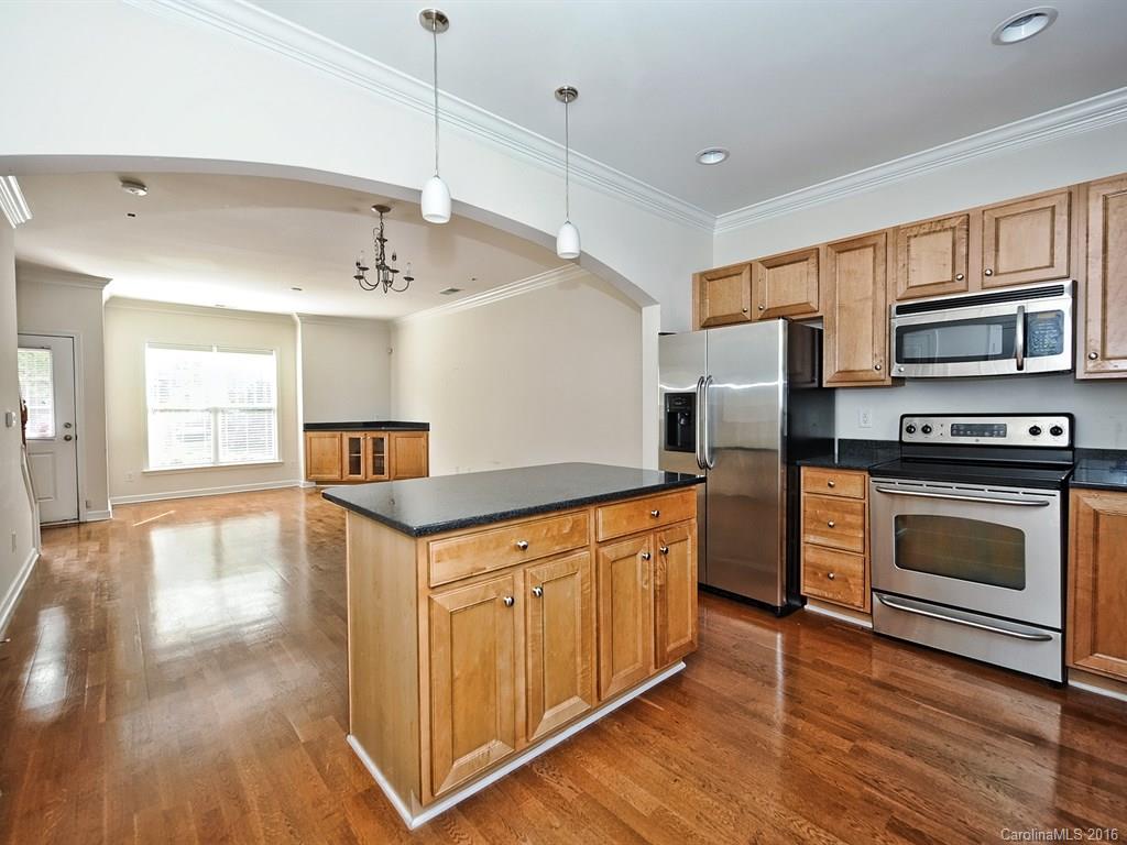 4142 Walker Road, Unit 4142 Charlotte, NC 28211 - Photo 10 of 22 a kitchen with stainless steel appliances granite countertop a stove and a refrigerator