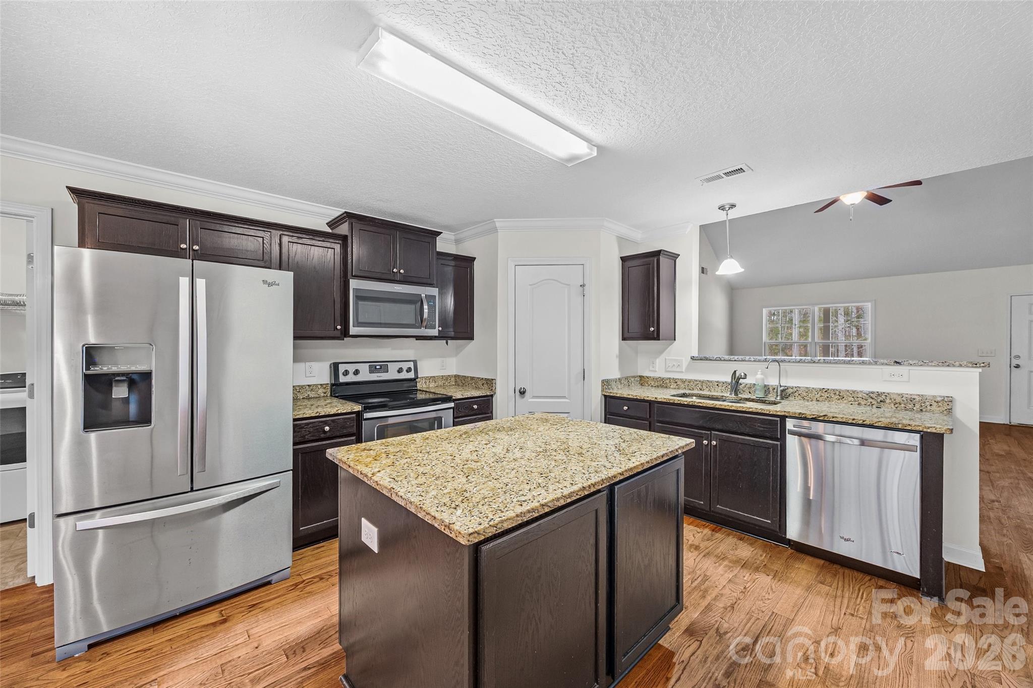 6115 Chandler Road Clover, SC 29710 - Photo 12 of 36 a kitchen with stainless steel appliances granite countertop a stove refrigerator sink and microwave