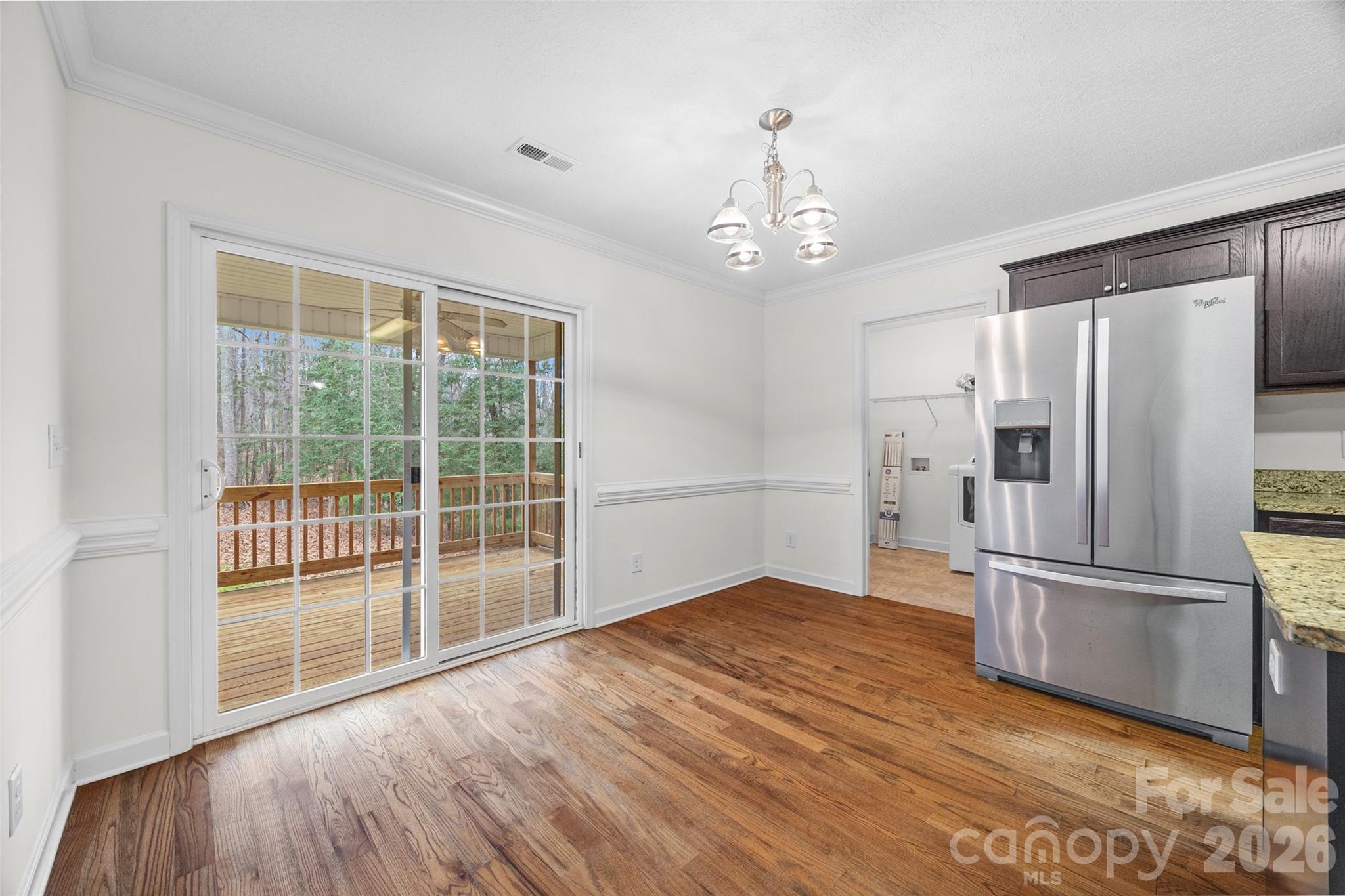6115 Chandler Road Clover, SC 29710 - Photo 14 of 36 a view of a kitchen with wooden floor a ceiling fan and windows