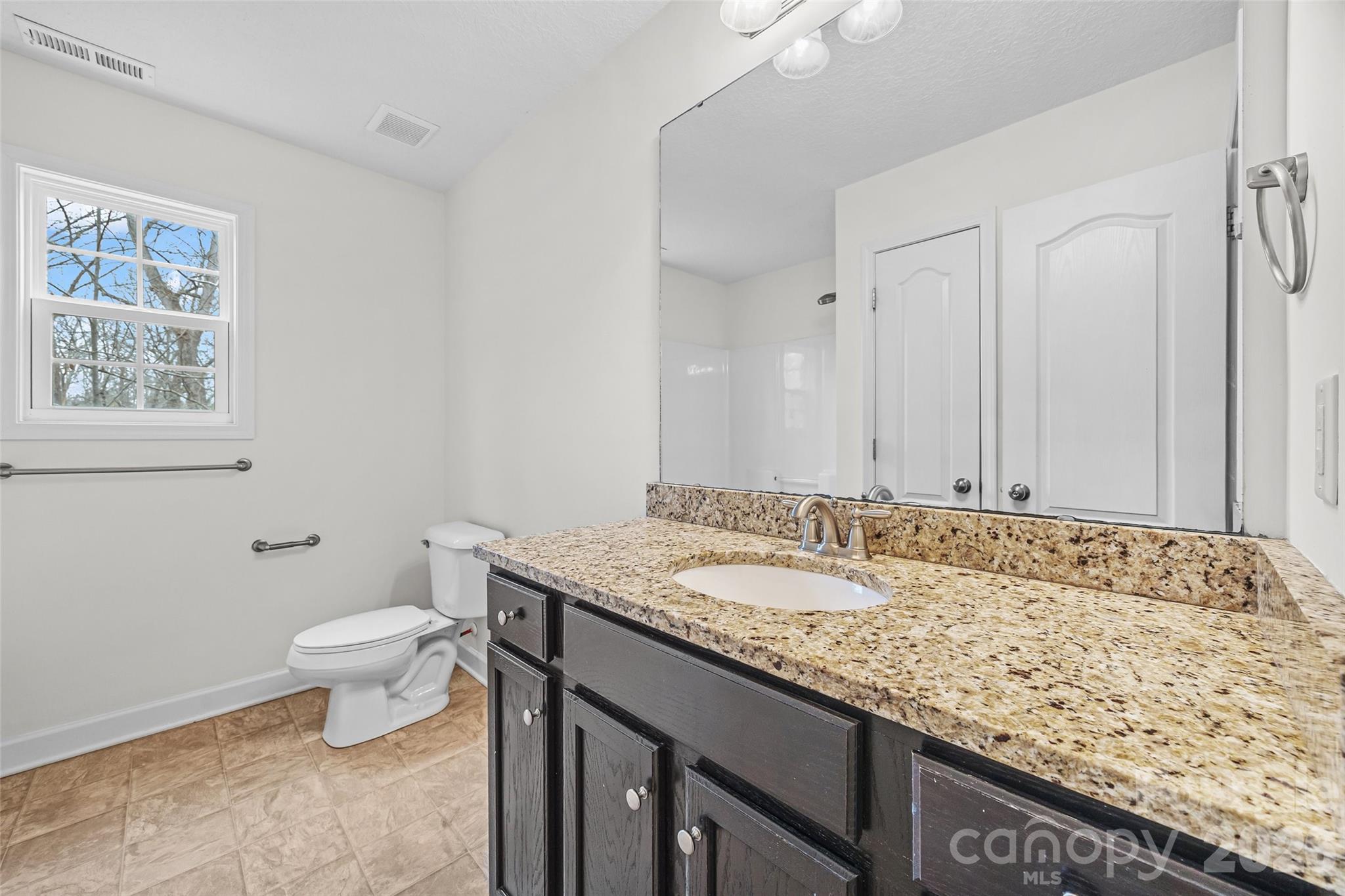 6115 Chandler Road Clover, SC 29710 - Photo 28 of 36 a bathroom with a granite countertop sink and a toilet