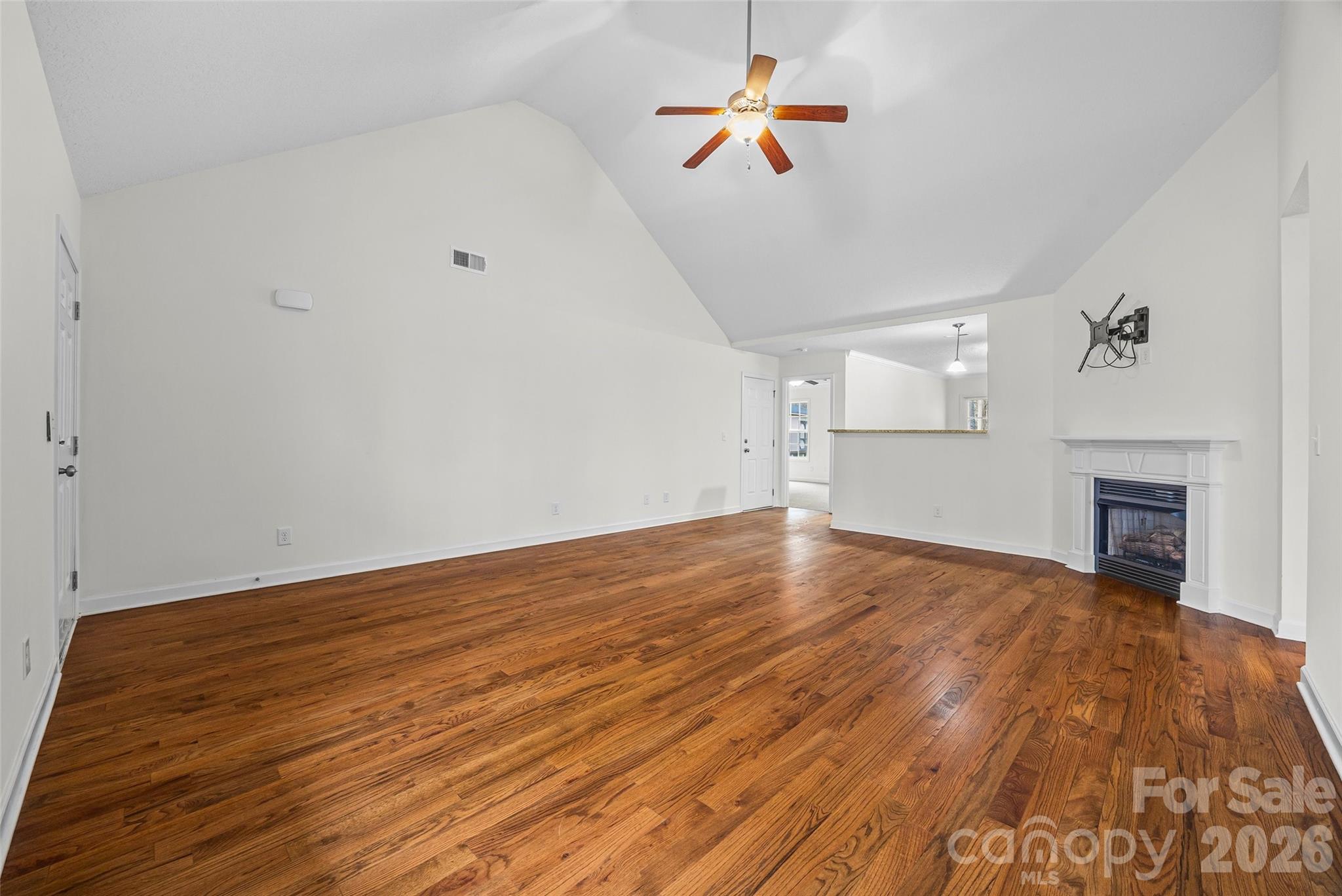 6115 Chandler Road Clover, SC 29710 - Photo 6 of 36 a view of empty room with wooden floor and fireplace