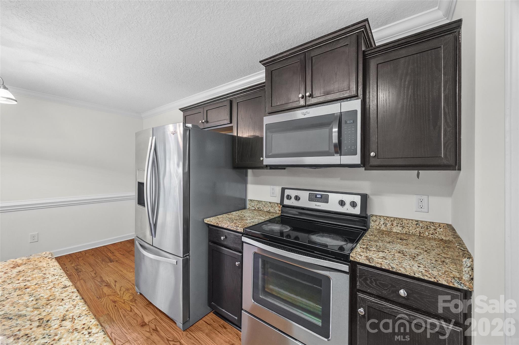 6115 Chandler Road Clover, SC 29710 - Photo 9 of 36 a kitchen with stainless steel appliances granite countertop a stove microwave and refrigerator