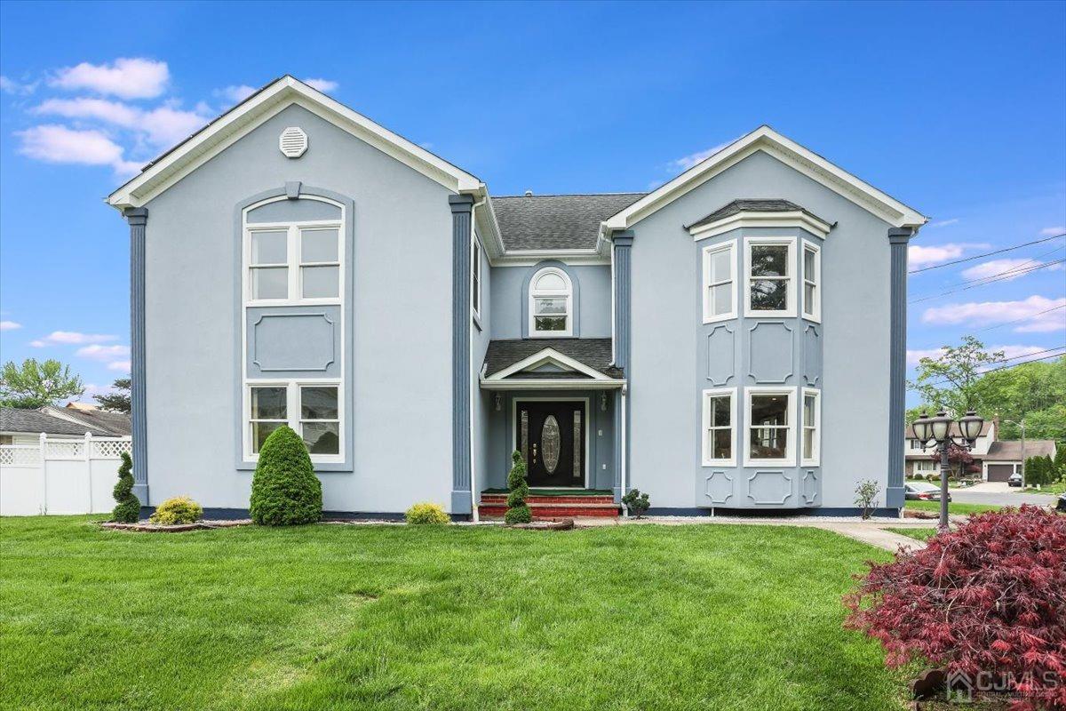 a front view of a house with a yard