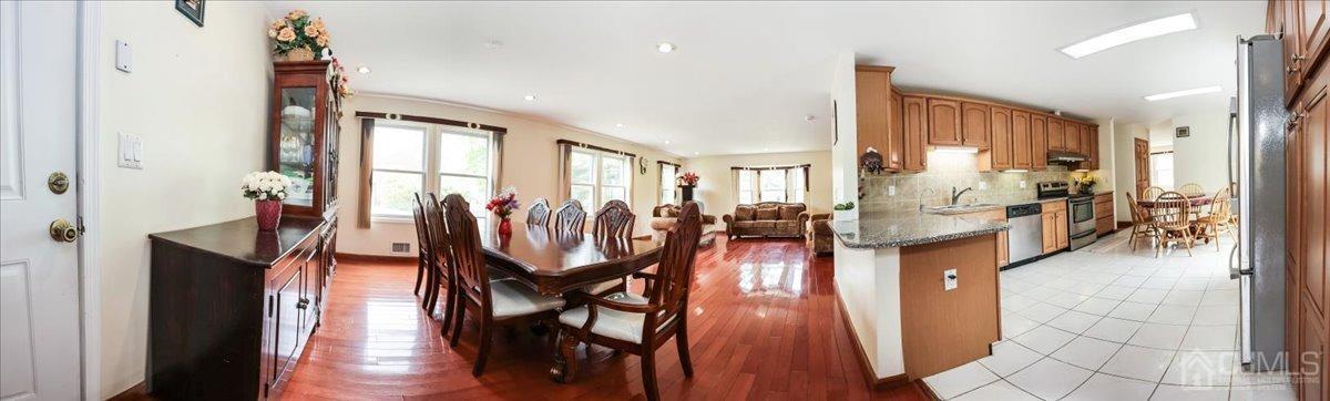 19 Elizabeth Avenue Edison, NJ 08820 - Photo 13 of 48 a dining room with wooden floor and a chandelier
