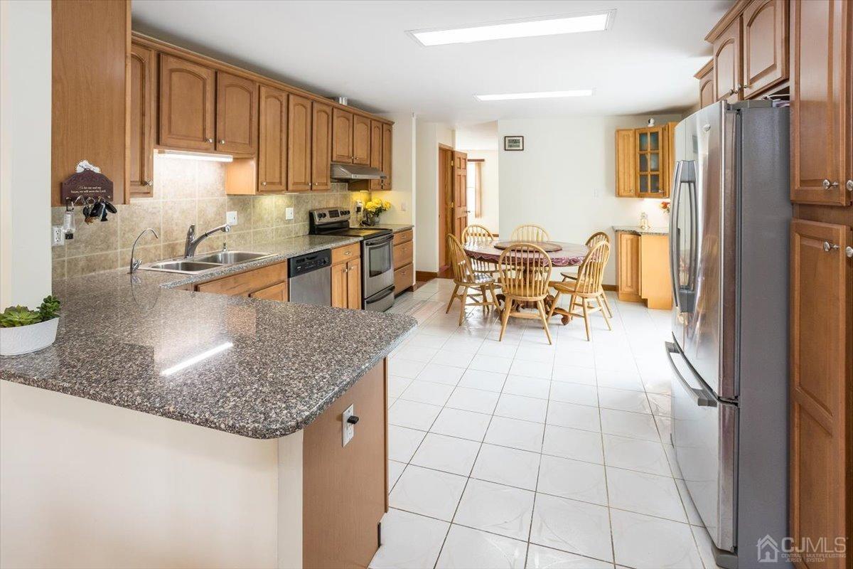 19 Elizabeth Avenue Edison, NJ 08820 - Photo 14 of 48 a kitchen with stainless steel appliances granite countertop a sink stove and cabinets