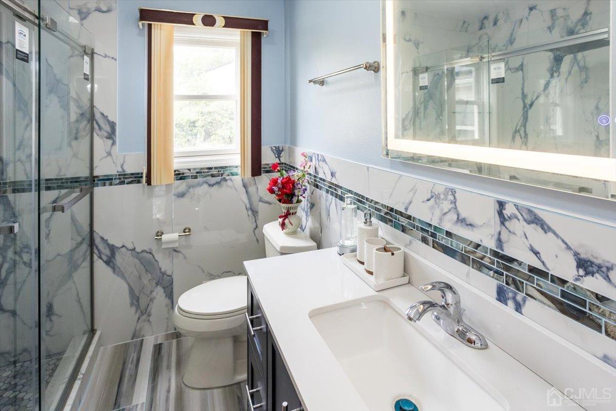 19 Elizabeth Avenue Edison, NJ 08820 - Photo 19 of 48 a bathroom with a sink toilet and shower