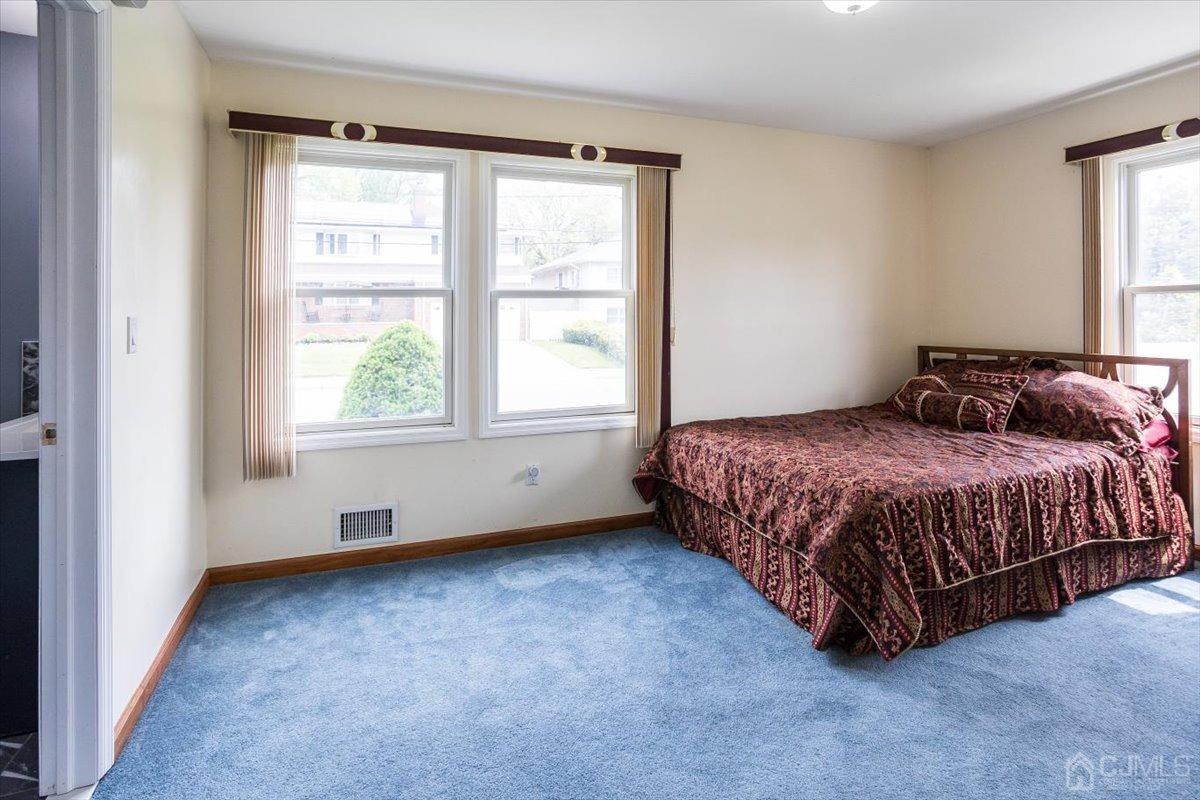 19 Elizabeth Avenue Edison, NJ 08820 - Photo 21 of 48 a bed sitting in a bedroom next to a window