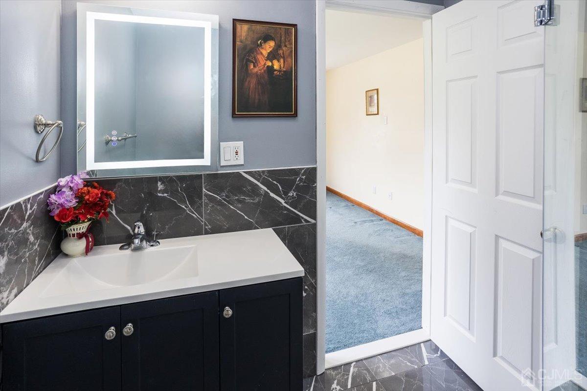 19 Elizabeth Avenue Edison, NJ 08820 - Photo 22 of 48 a bathroom with a sink and a mirror