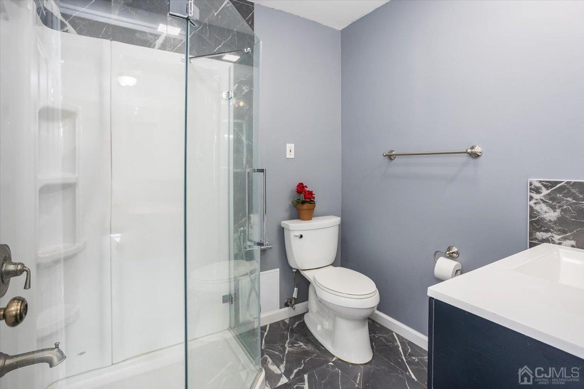 19 Elizabeth Avenue Edison, NJ 08820 - Photo 23 of 48 a bathroom with a toilet and a shower