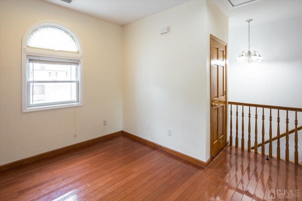 19 Elizabeth Avenue Edison, NJ 08820 - Photo 25 of 48 a view of empty room with wooden floor and fan