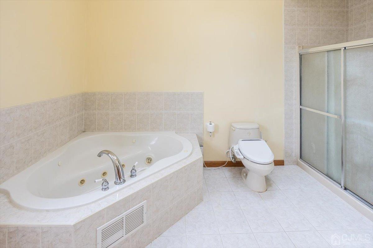 19 Elizabeth Avenue Edison, NJ 08820 - Photo 29 of 48 a white bath tub sitting next to a white toilet
