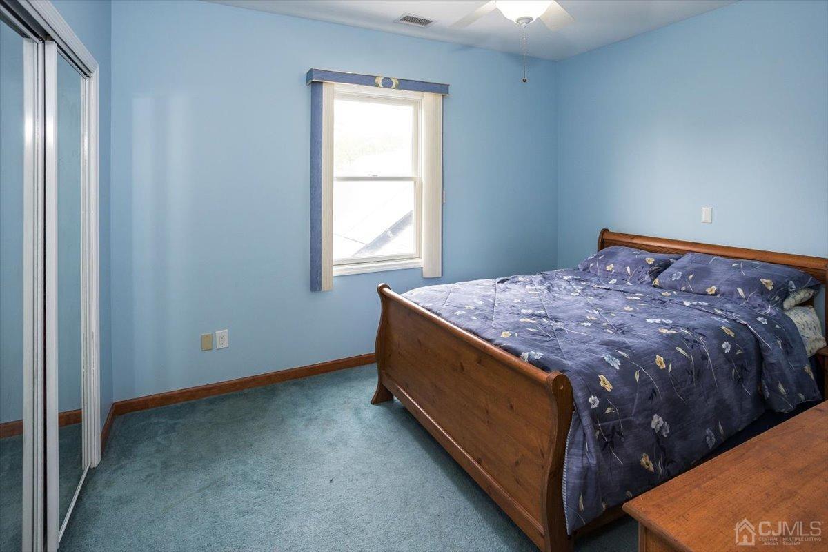 19 Elizabeth Avenue Edison, NJ 08820 - Photo 32 of 48 a bed sitting in a bedroom next to a window