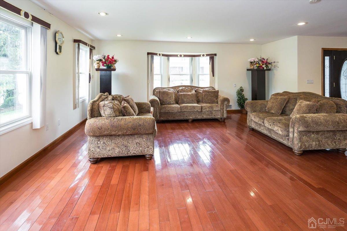 19 Elizabeth Avenue Edison, NJ 08820 - Photo 7 of 48 a living room with furniture and a wooden floor