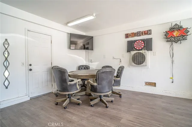 a view of a workspace with furniture and a fan