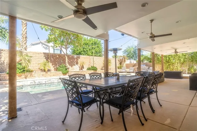 a dining room with furniture a chandelier and wooden floor