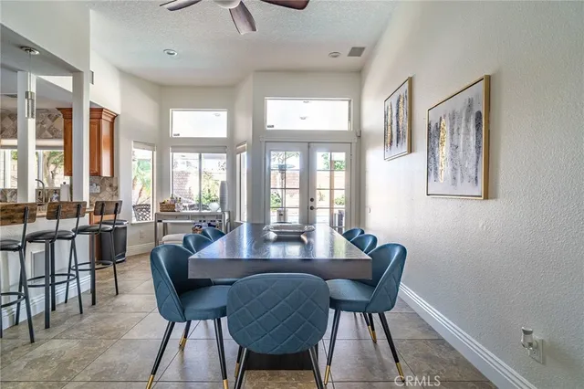 a view of a dining room with furniture large windows and wooden floor