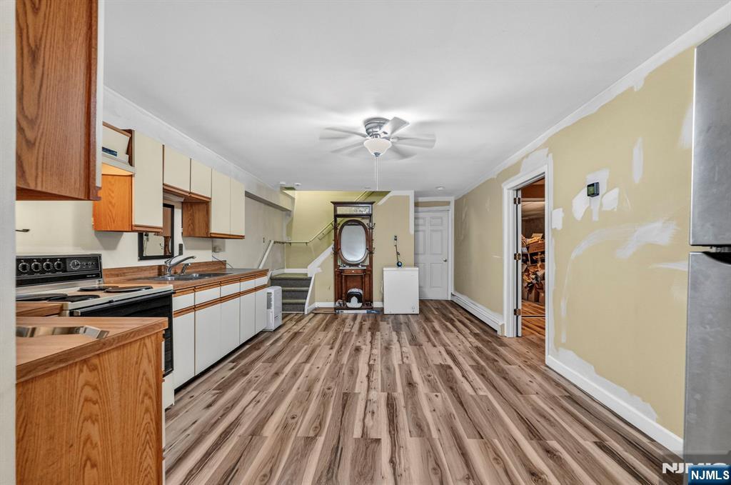 5110 Berkshire Valley Road Oak Ridge, NJ 07438 - Photo 40 of 49 a kitchen with a sink and wooden floor