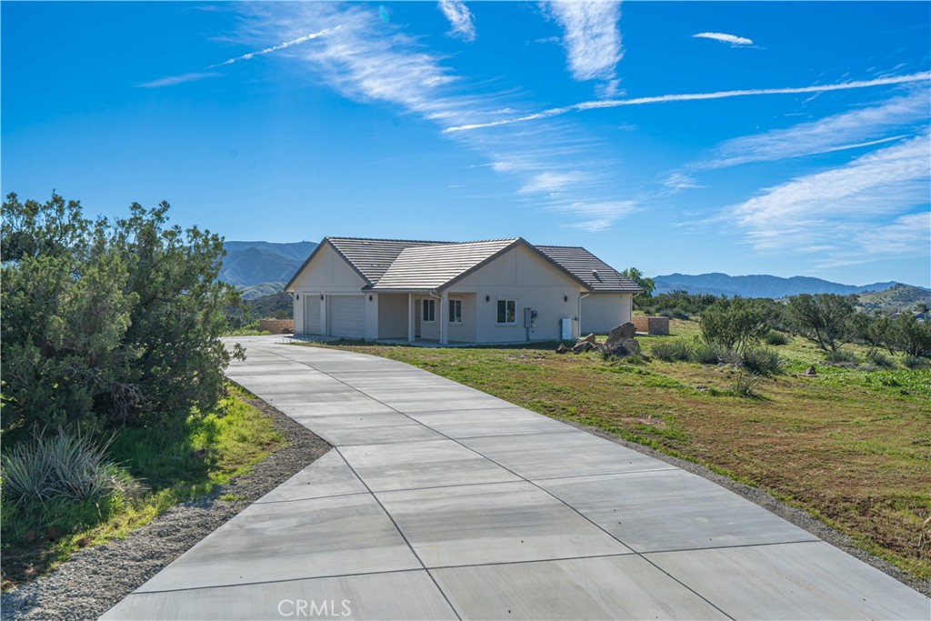 10540 Darling Road Agua Dulce, CA 91390 - Photo 3 of 56 a front view of a house with a yard