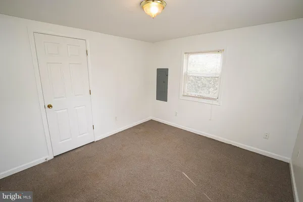 an empty room with windows and with an entryway