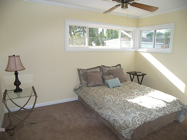 1040 Midway Road Northbrook, IL 60062 - Photo 9 of 18 a bed sitting in a bedroom next to a window