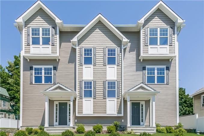 91 West Broad Street, Unit 5 Stamford, CT 06902 - Photo 1 of 1 a front view of a house with a yard and garage