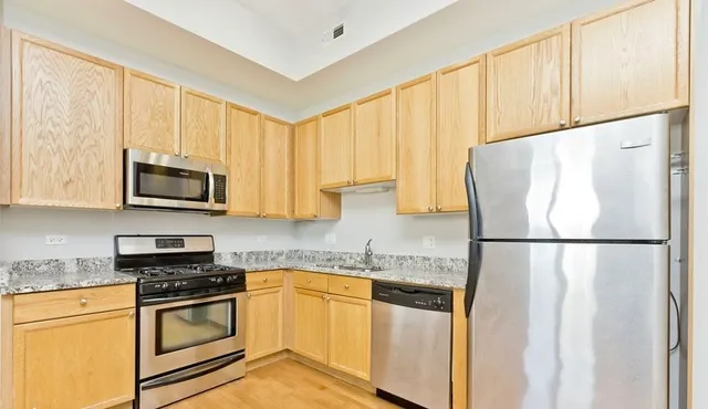 a white refrigerator freezer sitting in a kitchen