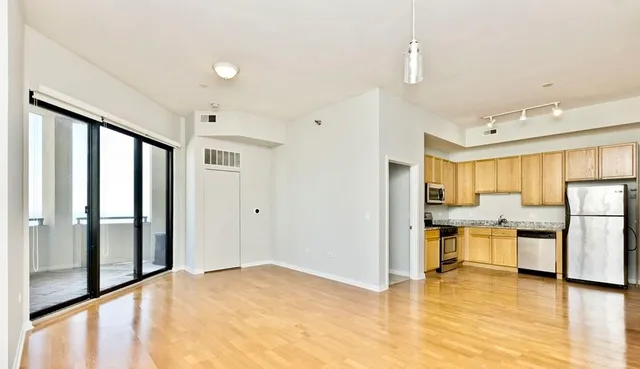 a view of a kitchen with a sink and a refrigerator