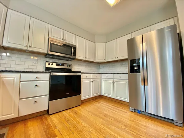 a kitchen with stainless steel appliances a stove sink and refrigerator