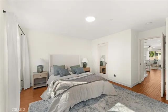 a bedroom with a bed and wooden floor