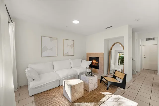 a living room with furniture a rug and a window