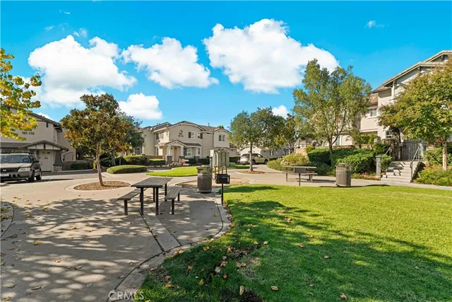 a view of a swimming pool with lawn chairs and a fire pit