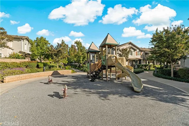 a view of a park with swings and slides