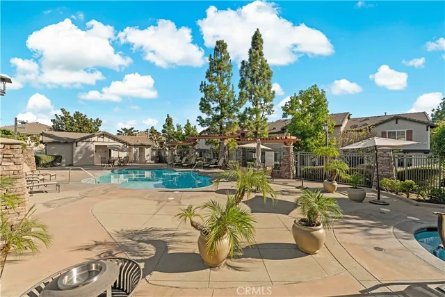 a view of a swimming pool with outdoor seating