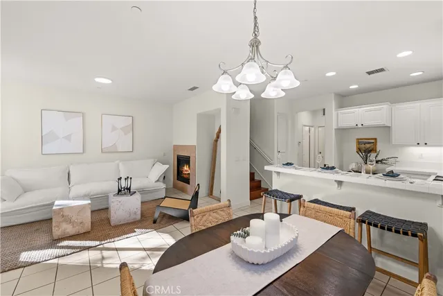 a view of a dining room with furniture a chandelier and wooden floor