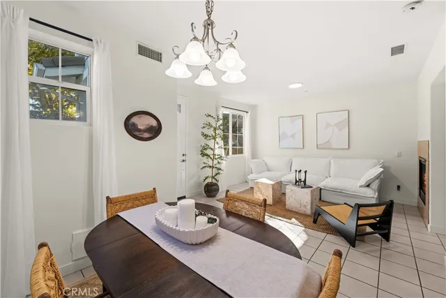 a living room with furniture a chandelier and a window